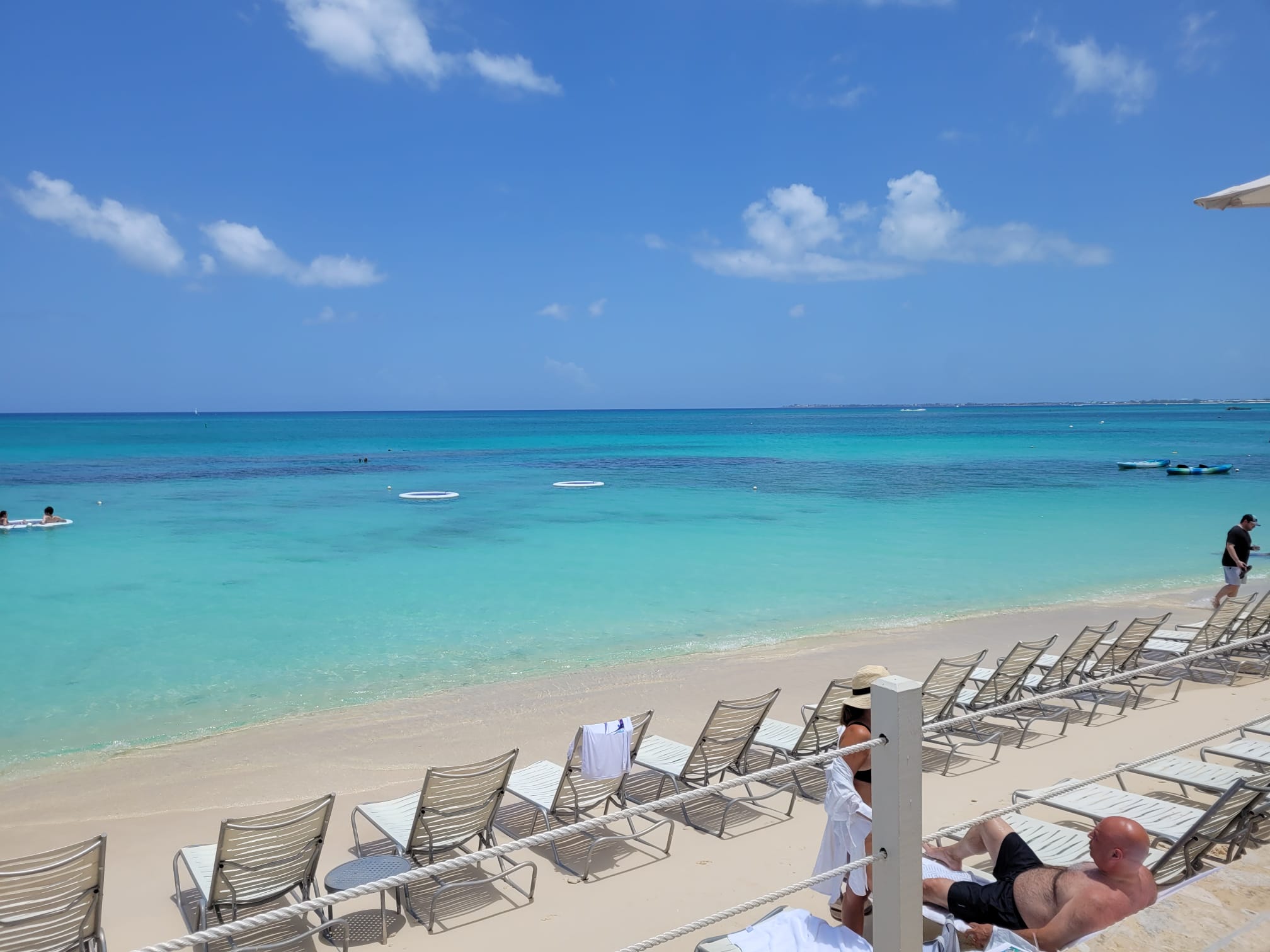 Seven Mile Beach turquoise water and lounge chairs near Camana Bay