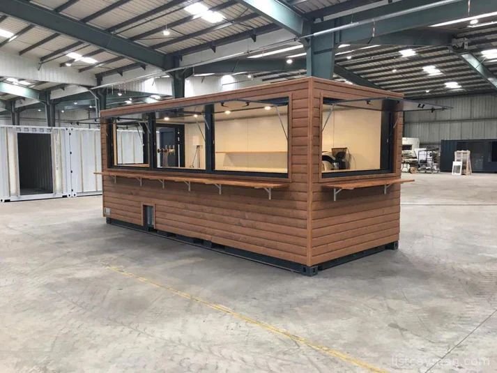 A 6-meter (20-foot) shipping container housing a cafe, with a very minimalist design